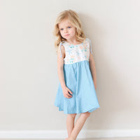 Girl wearing the blue starfish dress by bitty bambu