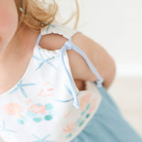 Close-up of adjustable shoulder straps on the blue starfish dress