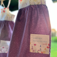 Handmade Girls' Wildflowers Dress with 'Love Her But Leave Her Wild' Quote Pocket | Shirred Back | Made in Maui, Hawaii