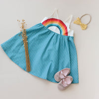 flat lay view of handmade rainbow dress with full twirly skirt by bitty bambu