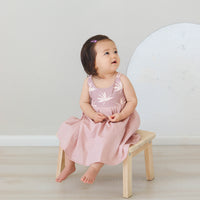 Girl wearing the 'Bird of Paradise' dress, showcasing the full skirt perfect for twirling
