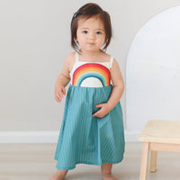Dress with rainbow bodice and teal full twirly skirt shown on a model walking
