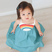 Dress with rainbow bodice and teal full twirly skirt shown on a model