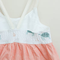 Back of the dress featuring a shirred elastic bodice for a stretchy, form-fitting look.