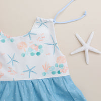 Close-up of adjustable shoulder straps on the blue starfish dress.