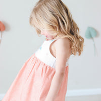 Handmade girls' Turtle (Honu) dress with fully lined bodice, made from 100% cotton, featuring a charming turtle design, made in Hawaii shown on model