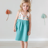 Girl wearing the Hula Girls dress, displaying the vibrant print and comfortable fit