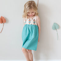 Girl wearing the Hula Girls dress, displaying the vibrant print and comfortable fit