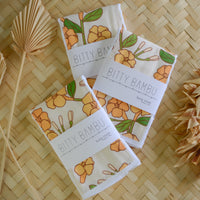 handmade puakenikeni flower baby burp cloth with green leaves and yellow flowers, ideal for newborns and baby gifts by bitty bambu