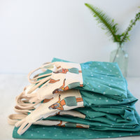 The Hula Girls dress neatly folded in a stacked pile