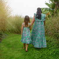 Back view of the dress featuring a shirred elastic bodice for a stretchy, flattering fit