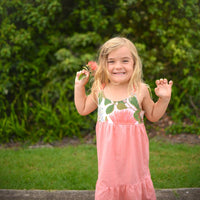 Girl wearing the Ohia Flower dress, displaying the vibrant native Hawaiian flower print and comfortable fit by bitty bambu