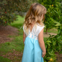 Back view of the Kalo Print Twirly Dress featuring a shirred elastic back and cotton lace straps for a comfortable fit