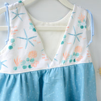 Back view of the girls' starfish dress showing the comfortable, loose fit design