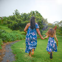 Mother and daughter wearing matching Navy Orchid print dresses for a Mommy and Me look