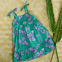 Handmade girls dress in Green Bougainvillea print with adjustable tie shoulder straps and ruffled hem, made out of 100% cotton