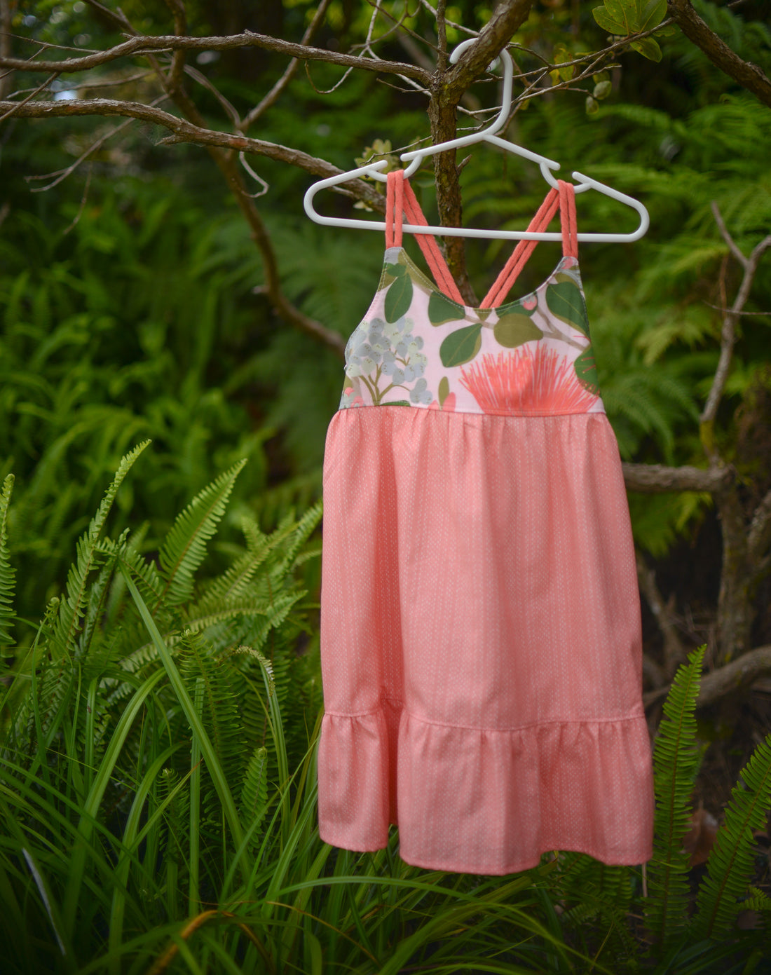 Ohia print dress hanging off of ohia tree
