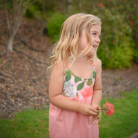 Girl wearing the Ohia Flower dress, displaying the vibrant native Hawaiian flower print and comfortable fit
