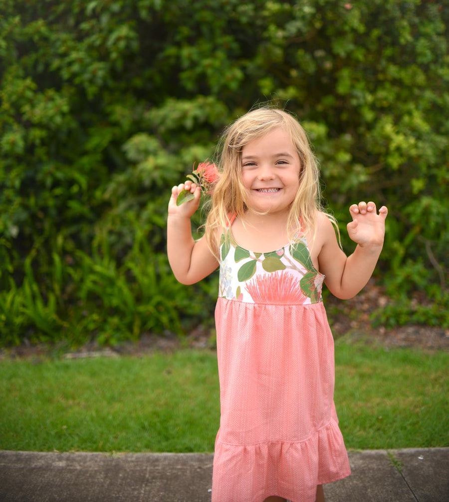 Girl wearing the Ohia Flower dress, displaying the vibrant native Hawaiian flower print and comfortable fit by bitty bambu
