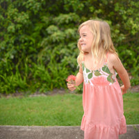 Girl wearing the Ohia Flower dress, displaying the vibrant native Hawaiian flower print and comfortable fit
