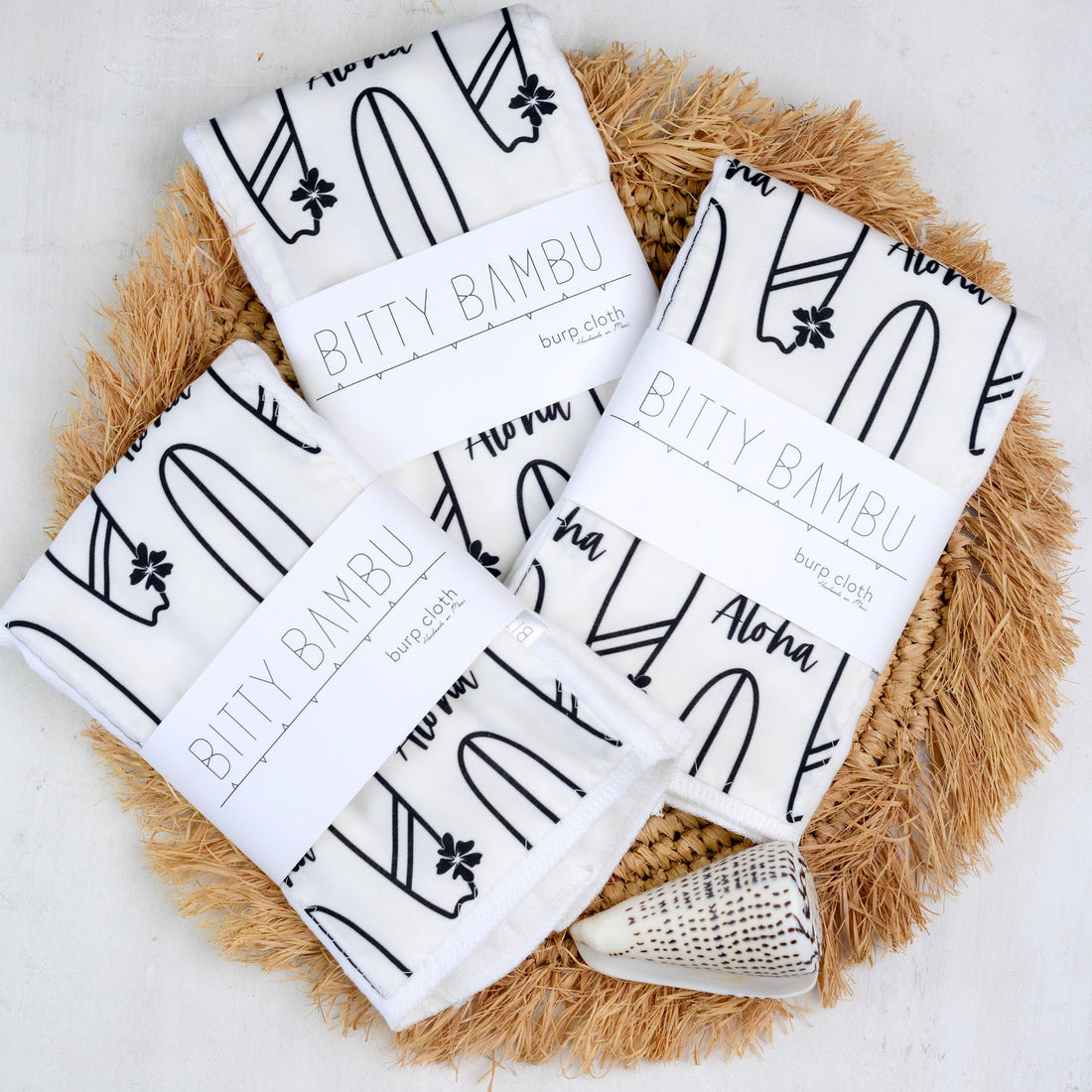 Bitty Bambu burp cloths on a textured surface