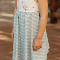 Close-up of the whale design on the bodice of the girls' dress