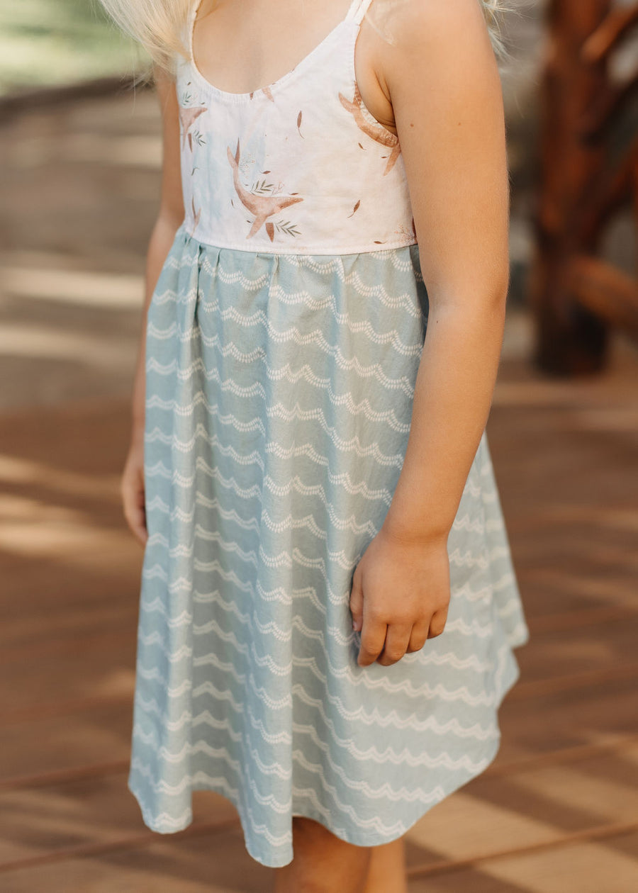 Close-up of the whale design on the bodice of the girls' dress