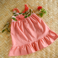 Ohia Flower layed flat highlighting the fully lined bodice and floral pattern and ruffled skirt