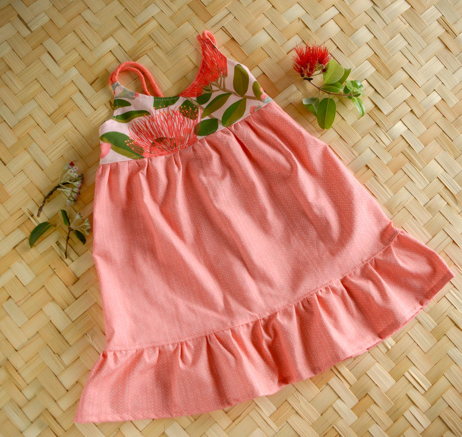 Ohia Flower layed flat highlighting the fully lined bodice and floral pattern and ruffled skirt