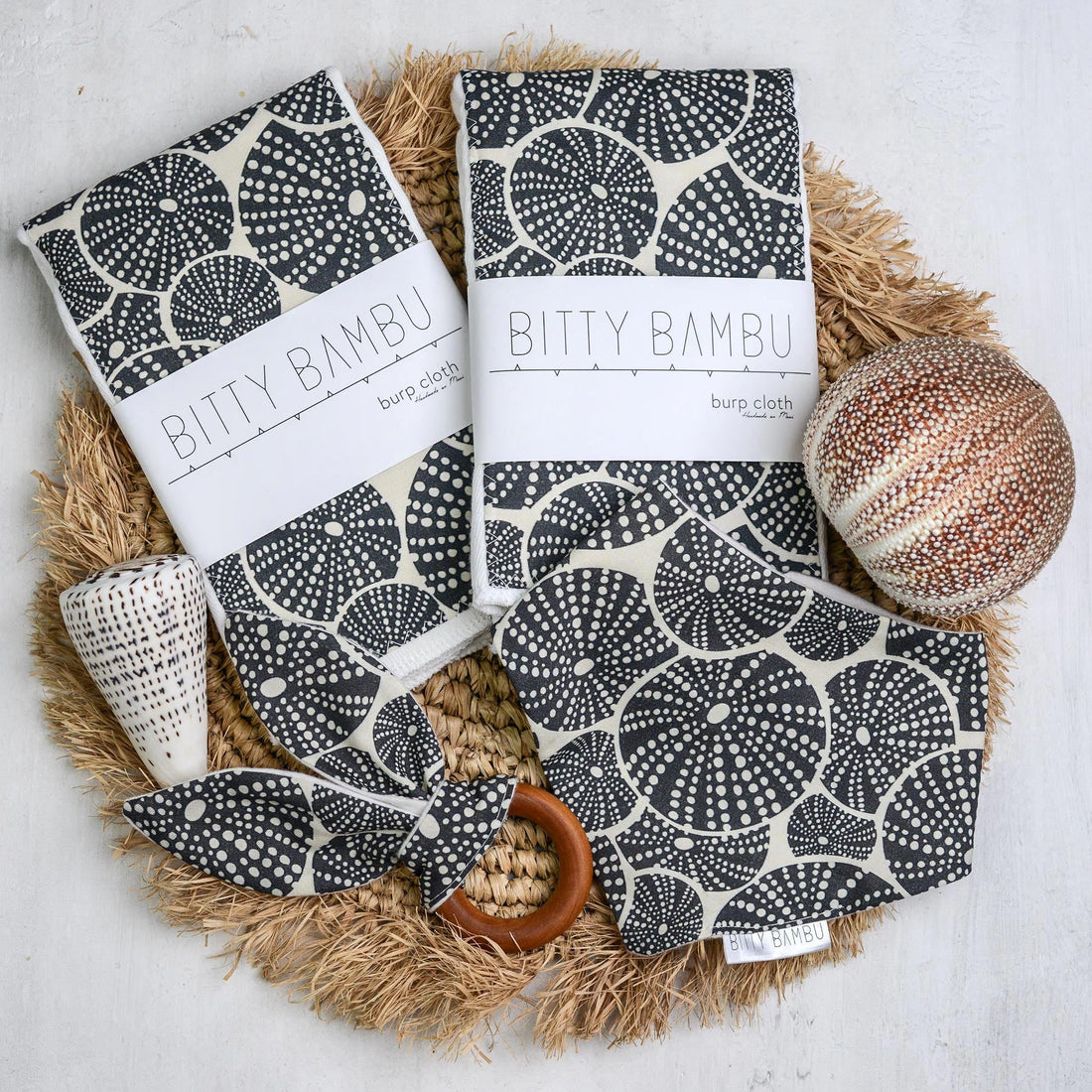 Bitty Bambu products including cloths and a ball on a textured surface
