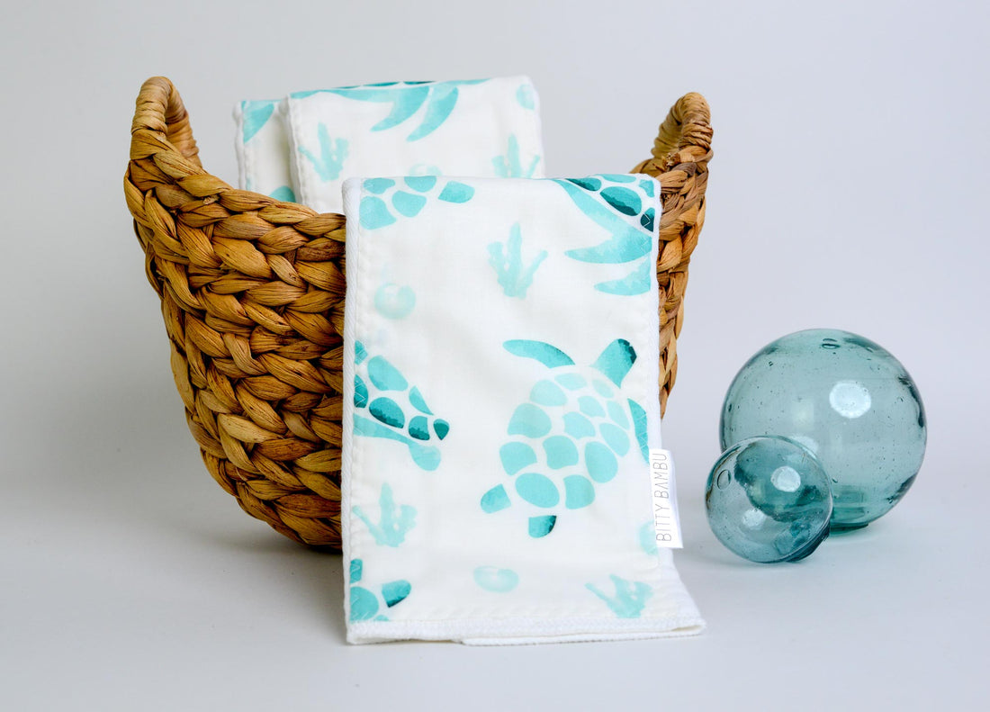 Towels with turtle pattern in a basket on a light background